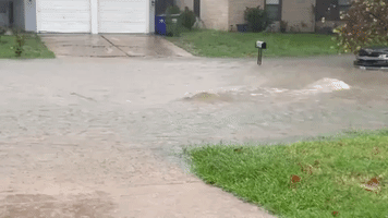 Floodwater Streams Through Dallas Suburb Streets