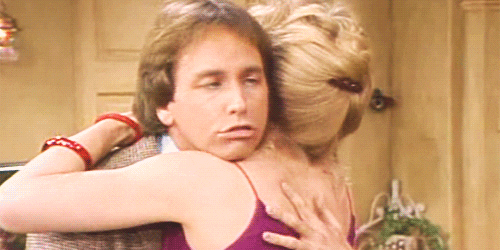 TV gif. Jack Ritter as Jack in Three's Company. He's hugging a woman and rubbing her back intensely as his eyes roll back in perverted pleasure.