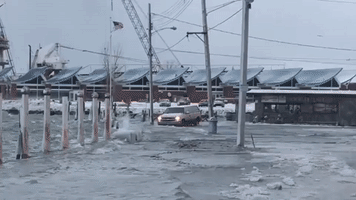 Driver Navigates Flooded Lake Erie Port Amid Crashing Waves