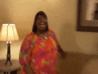 Parks and Recreation gif. Retta as Donna smiles excitedly with wide eyes and an open mouth. 