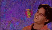 Video gif. A 90s era shot and font of a young man smiling and tilting his head as the text, "Wow," spins out behind him.