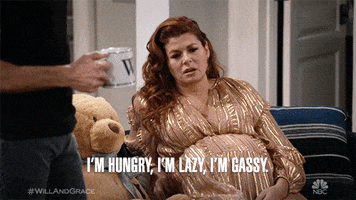 TV gif. A very pregnant Debra Messing as Grace in Will and Grace looks pained and says, “I'm hungry, I'm lazy, I'm gassy.”