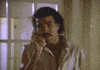 Celebrity gif. An emotional Lionel Richie sings into the phone, “Hello? Is it me you're looking for?” A woman on the other line lies in bed in her pajamas, holding the receiver to her ear and smiling.
