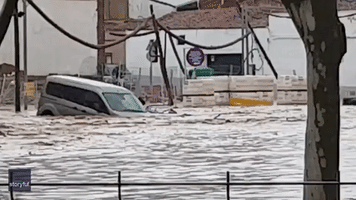 Car Floats Through Spanish Town Amid Flash Flooding