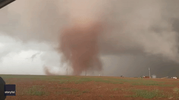 Motorists Drive Along Texas Highway as Tornado Spins Nearby