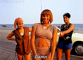 Music video gif. From the Whatta Man video, Sandra Denton, Cheryl James, and DJ Spinderella of Salt-N-Pepa stand together on a boardwalk in front of a convertible as Cheryl James folds her hands across her chest and says, “Damn.”