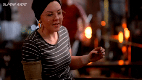 Reality TV gif. Woman on Blown Away looks up with her arms motioning up, and then looks over to her side. She says, “Yes!”