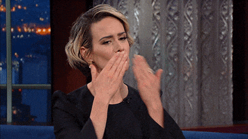 TV gif. Sarah Paulson, on the Late Show with Stephen Colbert, kisses her hands and then gestures a bow of respect with her hands.