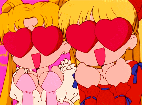 Anime gif. Sailor Moon and Sailor Venus’s eyes are big red hearts and they smile widely with their hands balled up in excitement under their chins.