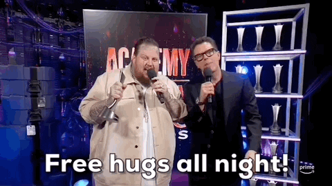 TV gif. On the interview stage at the 2024 ACM Awards,  while holding an award in one hand, singer and rapper Jelly Roll makes the announcement, 'Free hugs all night!'
