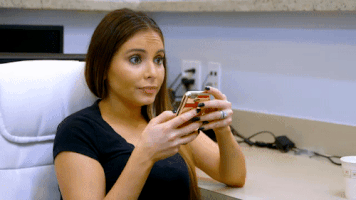 TV gif. Raquenel on Dr. Miami looks up from her phone to say "She cray cray!"