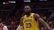 Sports gif. LeBron James of the Los Angeles Lakers strutting across the court in slow motion, looks at us and winks.