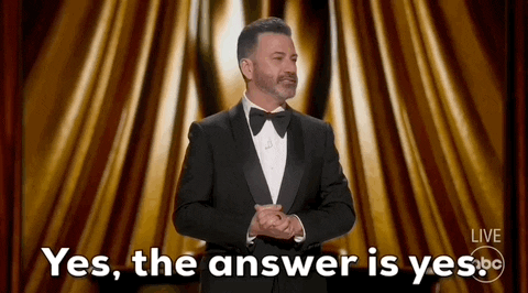 Oscars 2024 GIF. Jimmy Kimmel claspes his hands together and takes a dramatic pause before looking around the crowd and saying, "Yes. The answer is yes." 