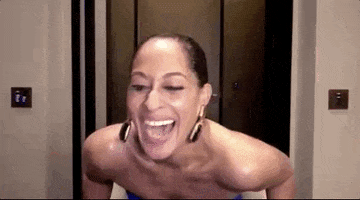 Celebrity gif. Tracee Ellis Ross at 2022 NAACP Image Awards laughing hard and leaning back in a chair.