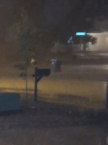 Trash Can Floats Down Colorado Street Amid Heavy Rainfall
