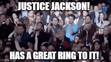 Meme gif. Large crowd of people rises to their feet, clapping uproariously. Text, "Justice Jackson! Has a great ring to it!"