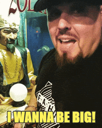 Celebrity gif. Pro Wrestler Brimstone looks at us, nodding in excitement as he says, “I wanna be big!”. He hurriedly turns to put a quarter into a Zoltar machine. 