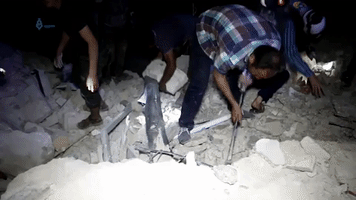 White Helmet Rescuers Work Overnight Following Deadly Airstrikes West of Aleppo