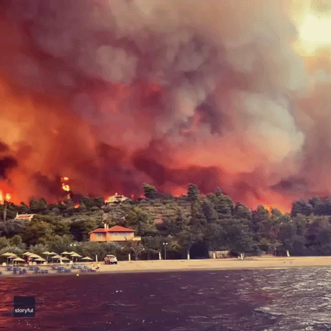 Wall of Flame Rises Behind Greek Beach as Wildfires Spread