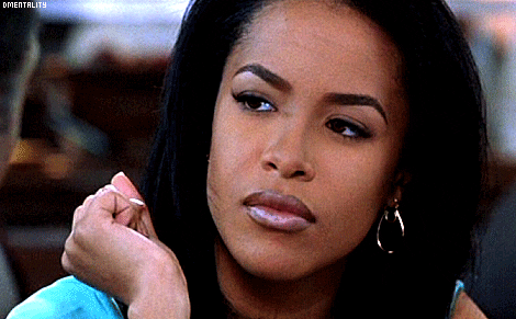 Celebrity gif. Giving an annoyed side eye, Aaliyah closes her eyes in frustration, turning away.