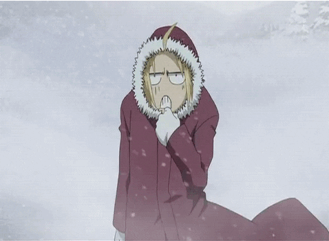 Anime gif. A person stands in a snowstorm, bundled in a winter coat, looking miserable.