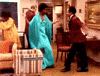 TV gif. Isabel Sanford as Louise and Sherman Hemsley as George in The Jefferson. The two are dressed in formal wear and begin dancing with one another and bumping booties as they jive to the music.