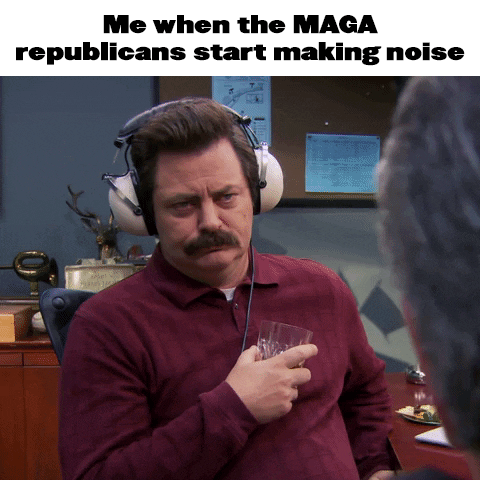Parks and Recreation gif. Nick Offerman as Ron Swanson nodding, from over the shoulder of an impassioned constituent, weary yet unflappable, wearing noise-canceling headphones and nursing a rocks glass of whiskey. Text, "Me when the Maga republicans start making noise."
