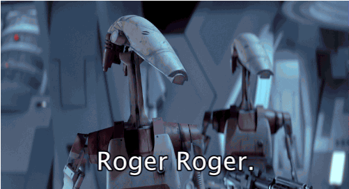 Star Wars gif. Two battle droids looking forward, holding big guns, nod in agreement. Text, "Roger roger."