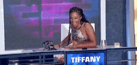 Celebrity gif. Tiffany Haddish laughs and leans back, clapping.