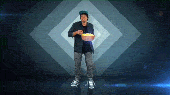 Video gif. Man dances, bopping side to side, with a bowl of popcorn in his hand. He take a handful of popcorn and eats it while dancing.