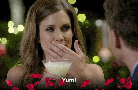 Reality TV gif. A woman from the Bachlorette AU is sipping a drink and she likes it, declaring, "Yum!"