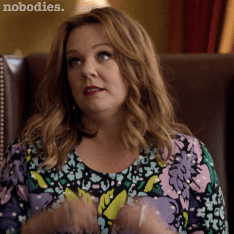 TV gif. Melissa McCarthy on Nobodies looks up with loving eyes and forms her hands into a heart shape.