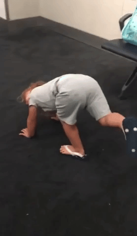 Little Girl Does Yoga While Waiting for Flight