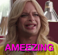 Celebrity gif. Nick Kroll as Liz in "PubLIZity," wearing a large blonde wig and makeup, darts his eyes to the side and says, "Ameezing," which appears as text.