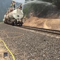 Water Train Hoses Down Woodland as Dixie Fire Burns in Northern California