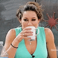 TV gif. A woman sipping from a mug does a huge spit take. She slowly doubles over with laughter.