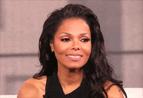 Celebrity gif. Janet Jackson laughs hysterically, leaning forward to face palm out of embarrassment.