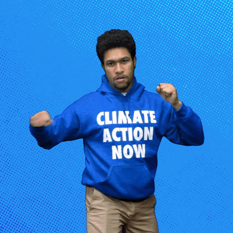 Digital art gif. Man wearing a blue sweatshirt that says "Climate action now" roundhouse punches the air, a comic strip-like "Pow!" symbol appearing in front of him, text inside of which reads, "Fight climate change!" everything against a blue background