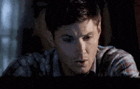 Video gif. Sick of working, an exhausted man looks around and shuts his laptop.
