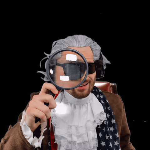 TechDogs-"Implications For Future AI Development"-"Artificial Intelligence (AI) GIF, A Person Wearing Shades And Wearing An Age Old Wardrobe From The 1800's With A Magnifying Glass And A Feather In His Hand Is Shocked To See Something On The Camera, Immediately Concludes He Saw Something, Text Says "That's AGI""