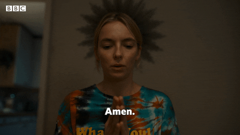 TV gif. Jodie Comer as Villanelle in Killing Eve holds her hands in front of her in prayer, bows her head and says, “Amen.”
