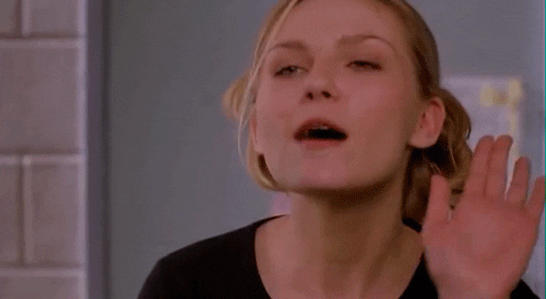 Movie gif. Kirsten Dunst as Torrance Shipman in Bring It On has a sassy look on her face as she waves her hand open and close, and says, “Buh Bye.”