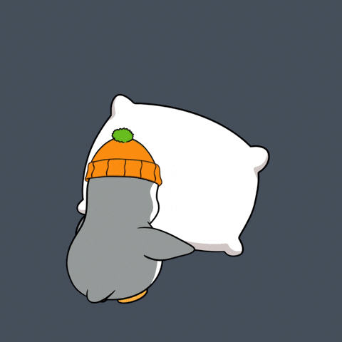 Kawaii gif. Pudgy penguin wears an orange beanie. It throws a pillow down on the floor, slaps it, then flops down on it.