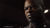 TV gif. Hisham Tawfiq as Dembe on The Blacklist has a serious, angry expression his face that changes to sudden shock 