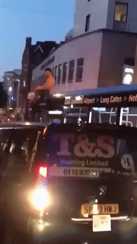 England Fan Celebrates World Cup Win on Roof of Nottingham Bus