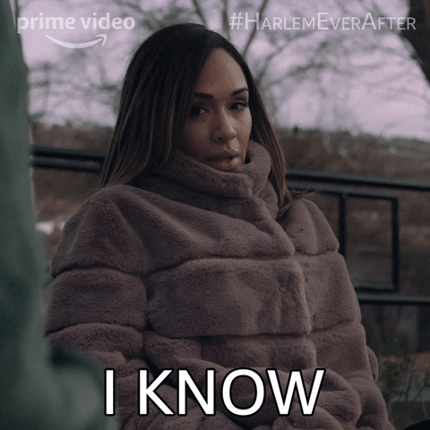 TV gif. Grace Byers as Quinn on Harlem, wearing a faux fur coat, glances up and says "I know." 