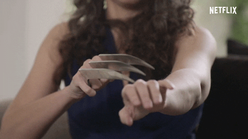 TV gif. A scene from Sex, Love, and Goop. A woman has Wolverine-like claws on one hand and she strokes the claws delicately down her arm.  