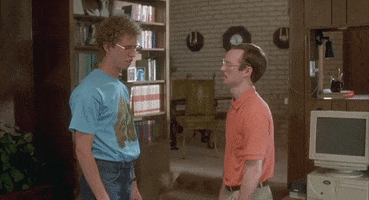 Movie gif. Jon Heder as Napoleon Dynamite slaps Aaron Ruell as Kip on the face and runs away.