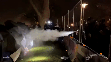 Protesters Create Umbrella Shield While Being Sprayed by Officers in Brooklyn Center