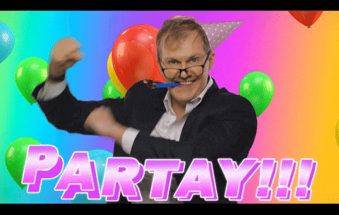 Video gif. A man wearing crooked glasses and a party hat dances in front of a colorful background with balloons and confetti. He has a paper horn hanging from his mouth and he grins at us. Text, "Partay!!!"